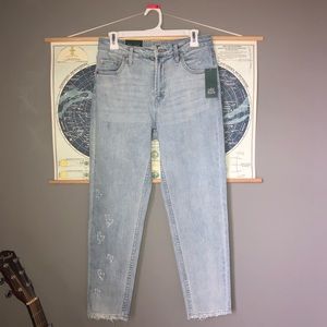 Hand embroidered distressed high rise mom jeans.
